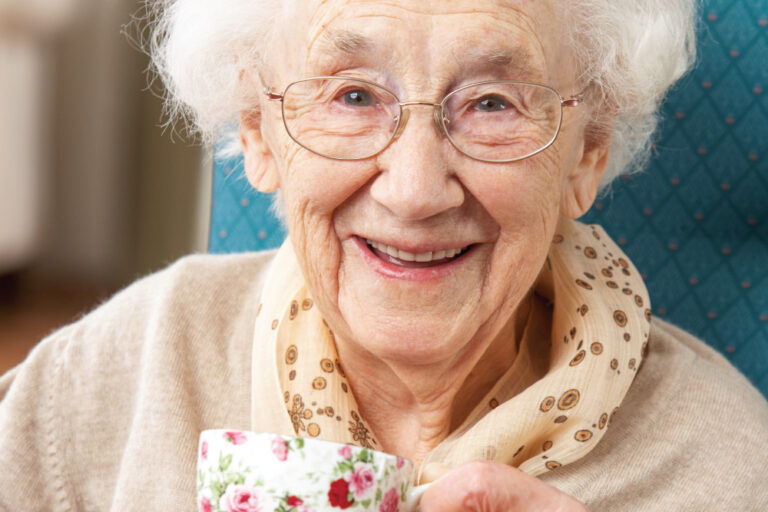 Happy Senior Woman drinking a cup of tea
