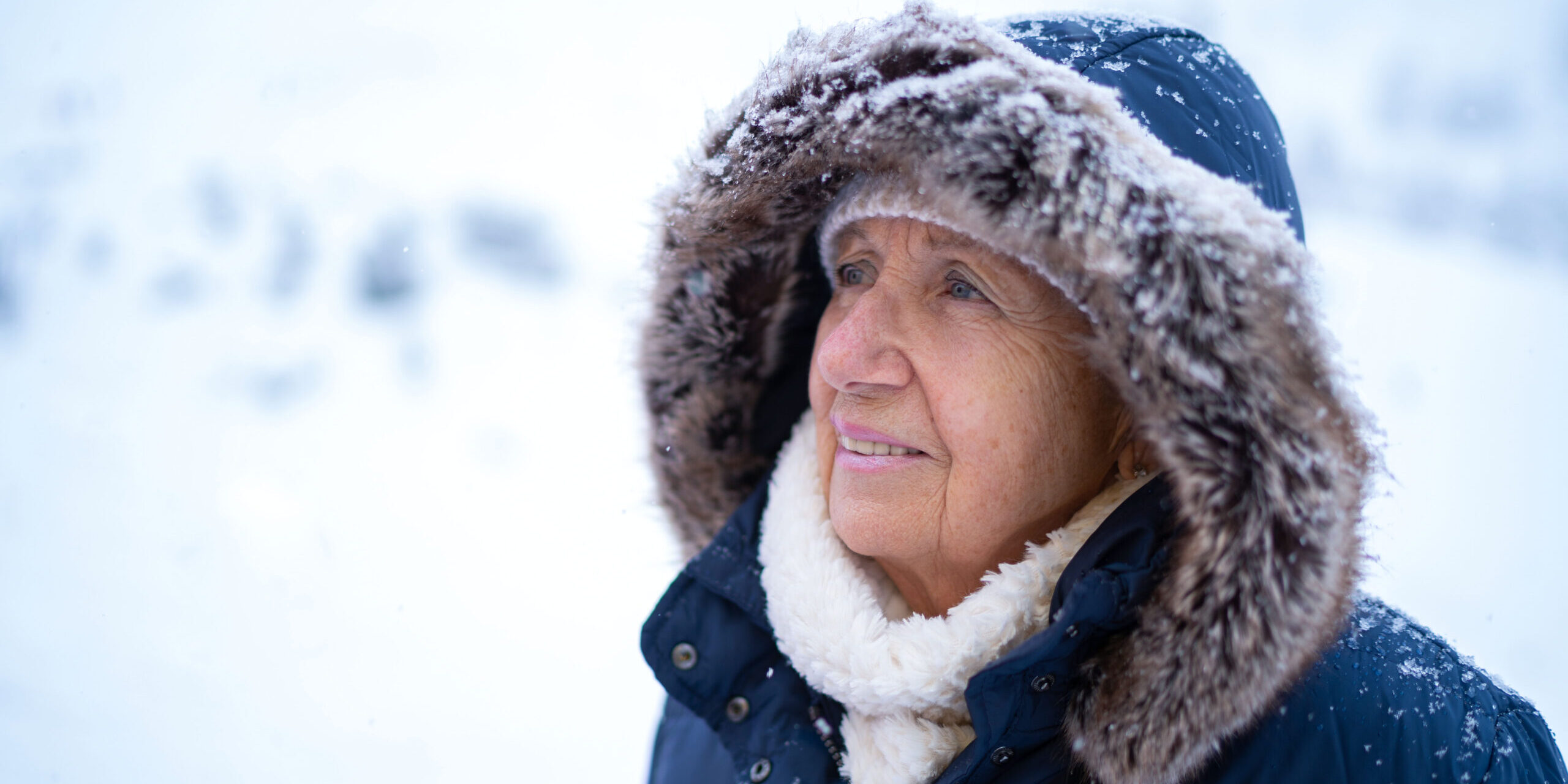 snowy winter senior woman portrait woman bundled up for winter